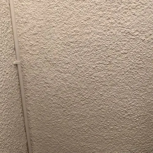 New double socket with surface-mounted trunking on a textured wall